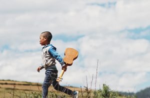 A Boy Holding A Ukulele